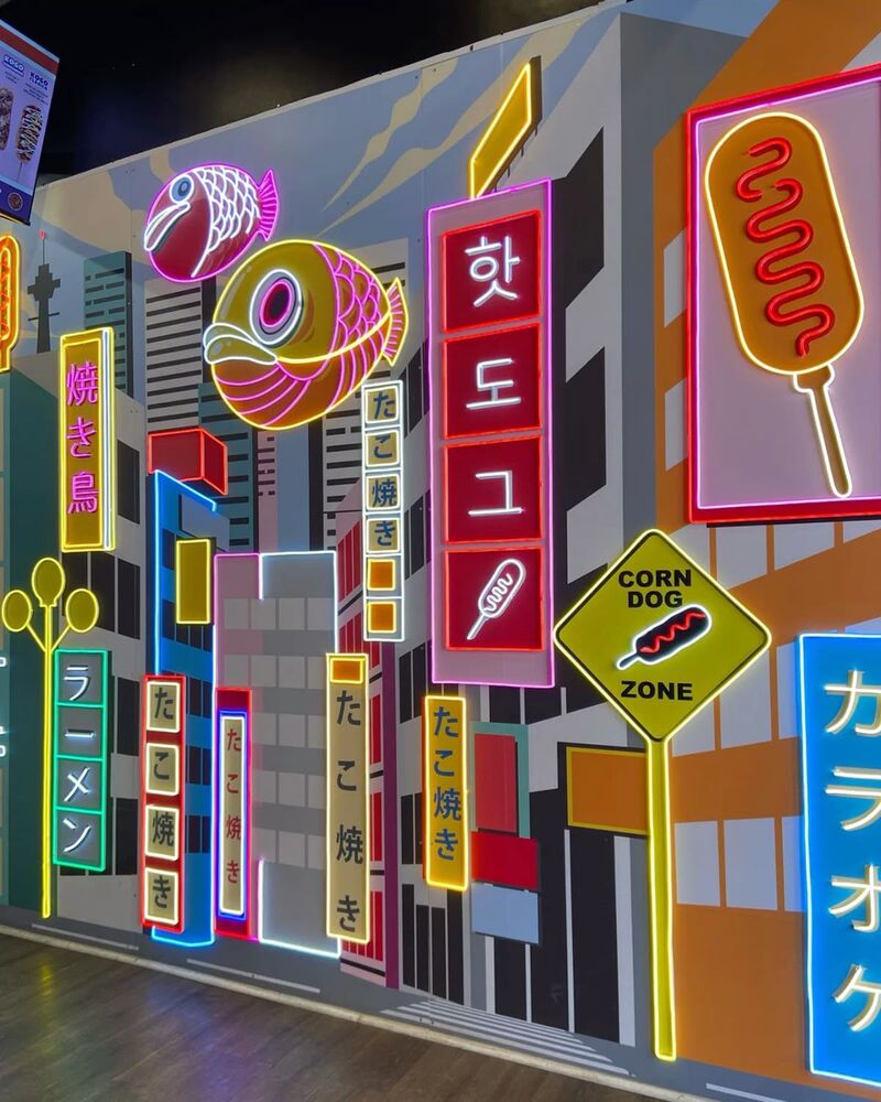 Custom neon mural signage installation on a food court wall
